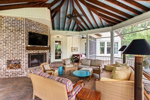 exterior space with ceiling fan, a fireplace, and lofted ceiling with beams