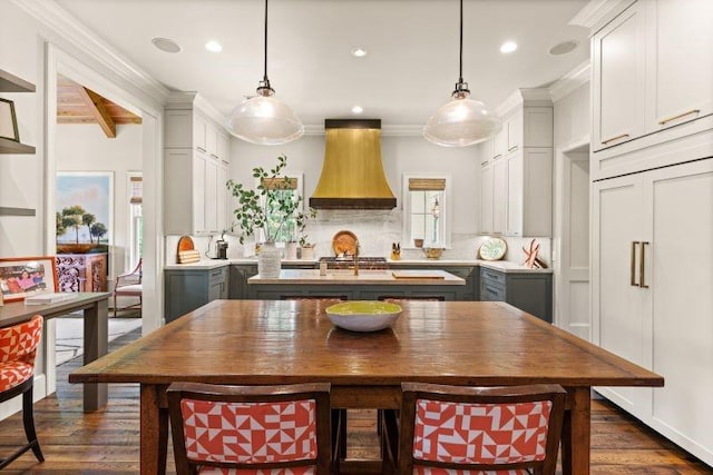 kitchen with decorative light fixtures, dark hardwood / wood-style flooring, gray cabinets, and premium range hood