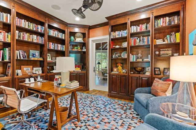 home office with ornamental molding and light hardwood / wood-style flooring