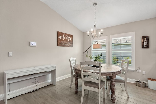 129 Chinquapin Dr, Saint Marys, GA 31558 - dining area featuring a chandelier, baseboards, wood finished floors, and vaulted ceiling