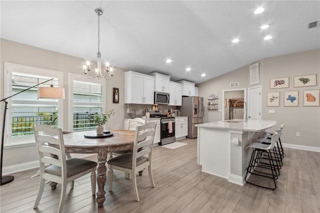 129 Chinquapin Dr, Saint Marys, GA 31558 - dining space with a chandelier, light wood finished floors, lofted ceiling, baseboards, and recessed lighting