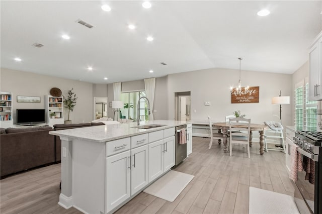 129 Chinquapin Dr, Saint Marys, GA 31558 - kitchen with appliances with stainless steel finishes, a sink, light wood-style floors, white cabinetry, and an island with sink