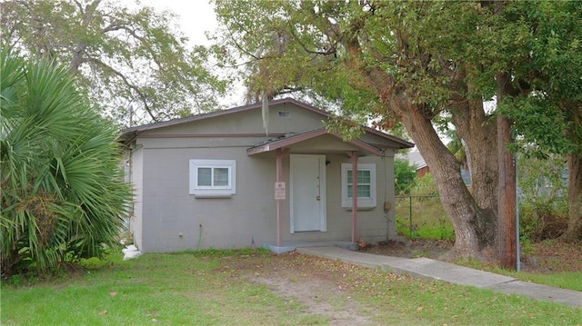 bungalow-style home featuring a front yard