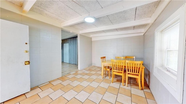 dining area with beamed ceiling