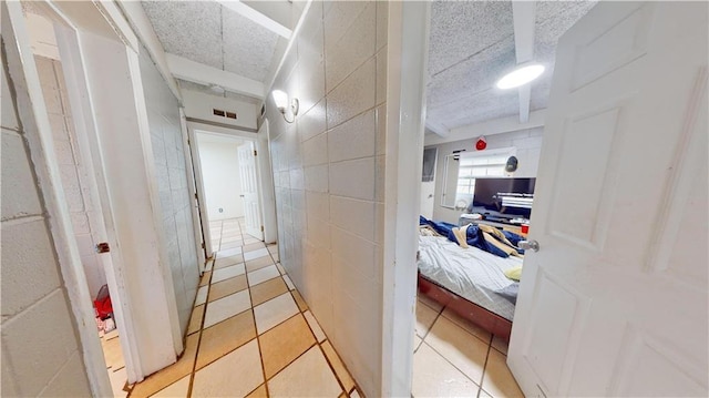 hallway featuring light tile patterned floors