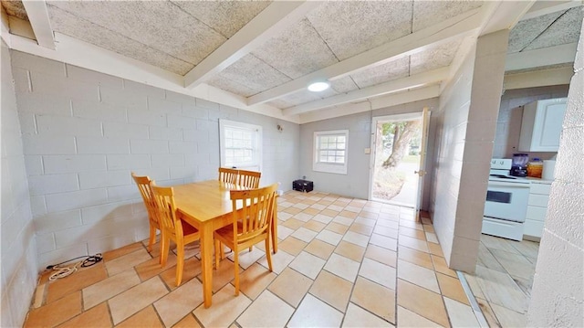 tiled dining area with lofted ceiling with beams