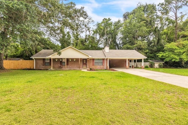 122 Tyson Ln, Allenhurst, GA 31301 - single story home with concrete driveway, a chimney, an attached carport, brick siding, and covered porch