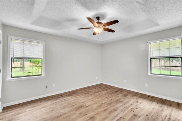 122 Tyson Ln, Allenhurst, GA 31301 - empty room with plenty of natural light, a textured ceiling, light wood-type flooring, and ceiling fan