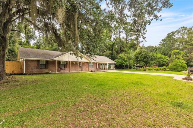 122 Tyson Ln, Allenhurst, GA 31301 - view of front of home featuring driveway, a carport, and covered porch