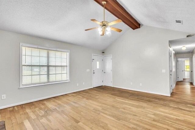 122 Tyson Ln, Allenhurst, GA 31301 - unfurnished living room with a ceiling fan, light wood-type flooring, attic access, and a textured ceiling