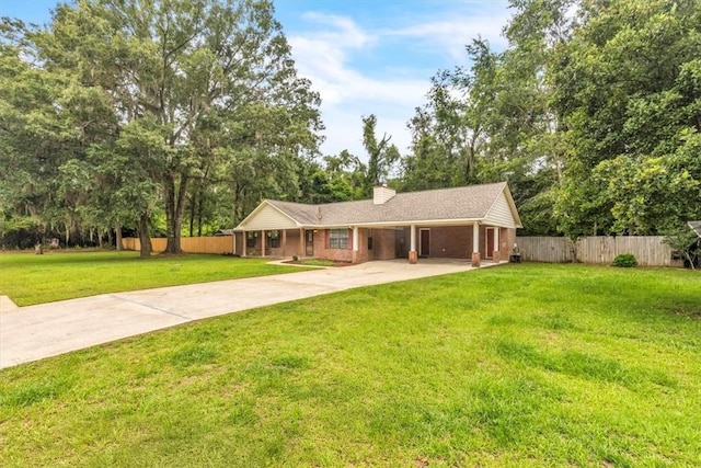 122 Tyson Ln, Allenhurst, GA 31301 - single story home with driveway, an attached carport, a chimney, and view of scattered trees