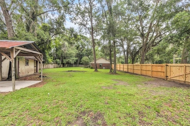 122 Tyson Ln, Allenhurst, GA 31301 - fenced backyard featuring view of wooded area and a patio