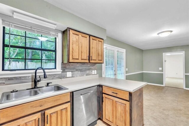 122 Tyson Ln, Allenhurst, GA 31301 - kitchen with stainless steel dishwasher, a peninsula, light countertops, and decorative backsplash