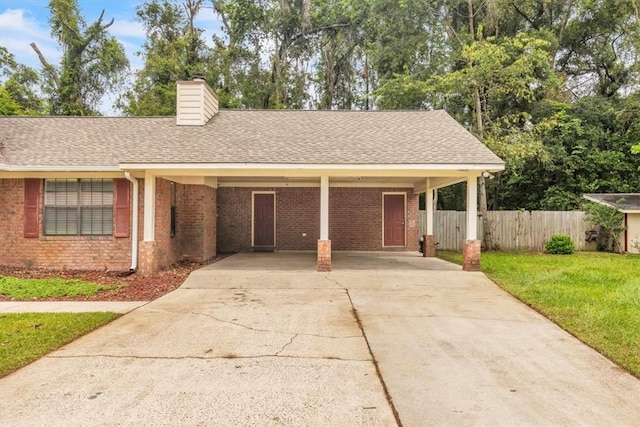 122 Tyson Ln, Allenhurst, GA 31301 - ranch-style house with driveway, brick siding, a chimney, a carport, and a shingled roof