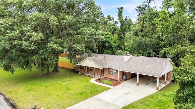 122 Tyson Ln, Allenhurst, GA 31301 - view of front of property featuring concrete driveway, an attached carport, a chimney, and a shingled roof