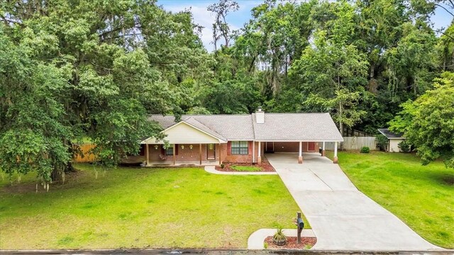 122 Tyson Ln, Allenhurst, GA 31301 - single story home featuring concrete driveway, a chimney, a carport, and covered porch