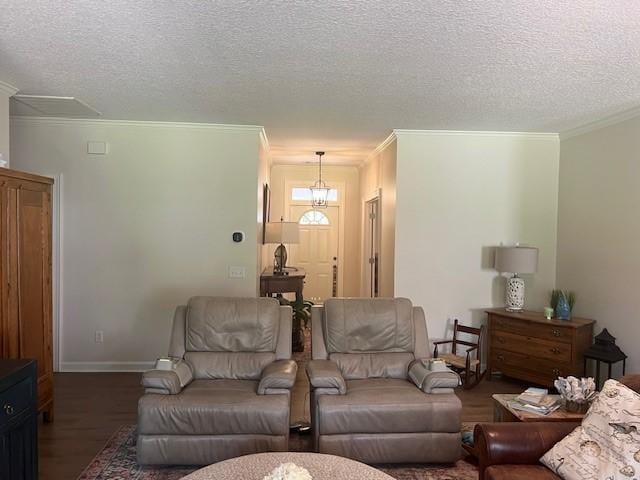 1186 Winterberry Ct NE, Townsend, GA 31331 - living area featuring ornamental molding, wood finished floors, a textured ceiling, baseboards, and a chandelier