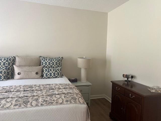1186 Winterberry Ct NE, Townsend, GA 31331 - bedroom featuring dark wood-style floors and baseboards