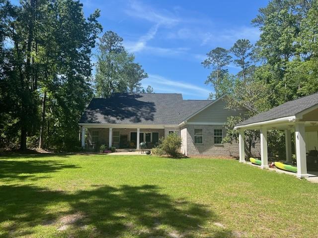 1186 Winterberry Ct NE, Townsend, GA 31331 - back of house with a yard and a porch