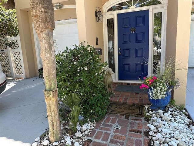 entrance to property featuring stucco siding