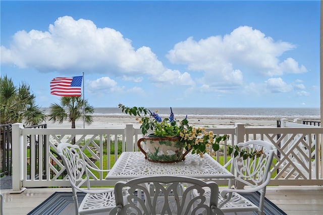balcony with view of water and beach