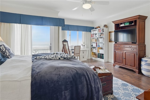 bedroom featuring wood finished floors, crown molding, and a ceiling fan