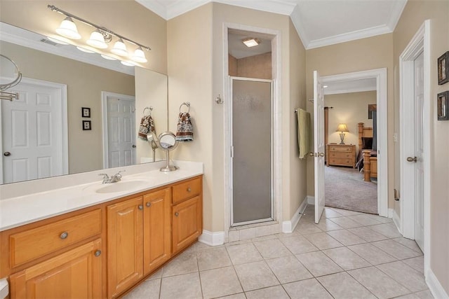 bathroom with vanity, tile patterned floors, a shower with shower door, and ornamental molding