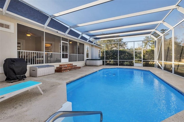 view of pool featuring a lanai, grilling area, a patio, and a hot tub