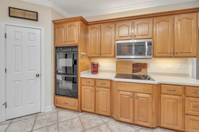 kitchen with light tile patterned floors, crown molding, and black appliances