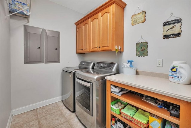 clothes washing area featuring cabinets, electric panel, and separate washer and dryer