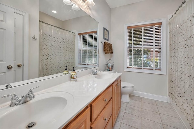 bathroom with toilet, vanity, tile patterned floors, and walk in shower