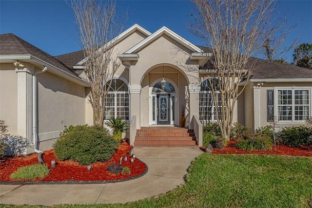 entrance to property with a lawn