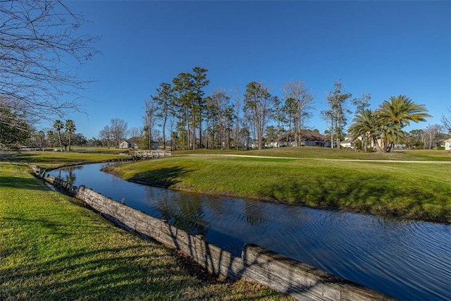 view of community featuring a water view and a yard