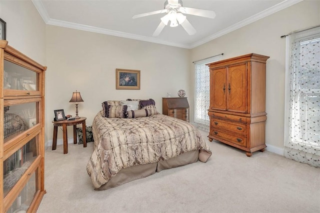 carpeted bedroom featuring ceiling fan and ornamental molding