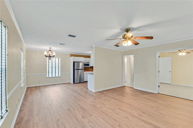 unfurnished living room featuring light wood finished floors, ceiling fan with notable chandelier, visible vents, and ornamental molding