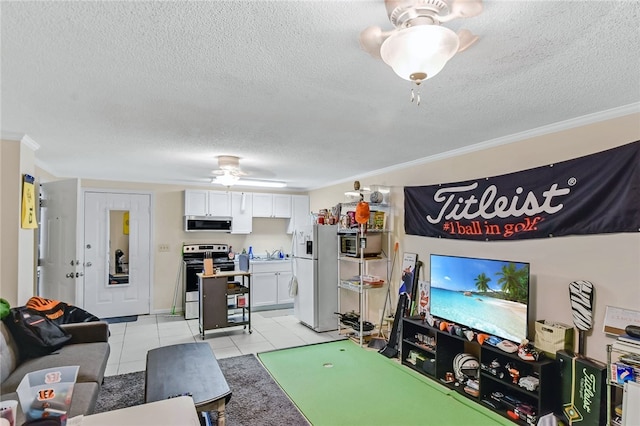 rec room featuring ornamental molding, light tile patterned flooring, a textured ceiling, and ceiling fan