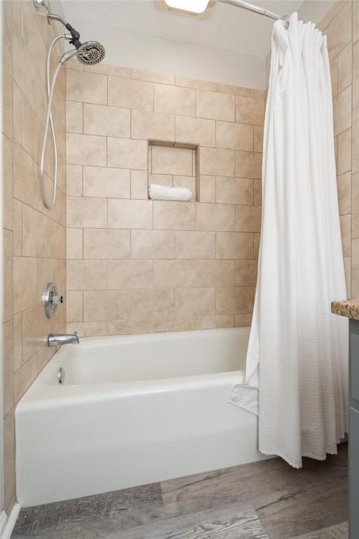 bathroom with shower / tub combo, vanity, and hardwood / wood-style flooring