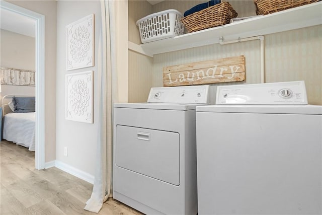 laundry area featuring light wood-type flooring and independent washer and dryer