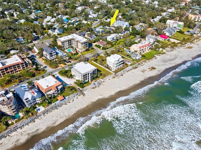 birds eye view of property featuring a beach view and a water view