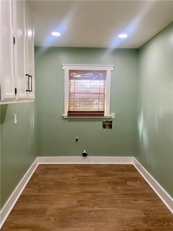 laundry room with hookup for an electric dryer, cabinets, dark wood-type flooring, and hookup for a washing machine