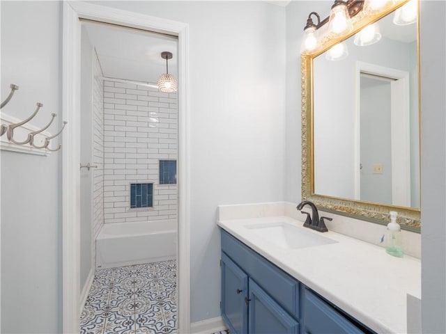 bathroom featuring tiled shower / bath, vanity, and tile patterned flooring