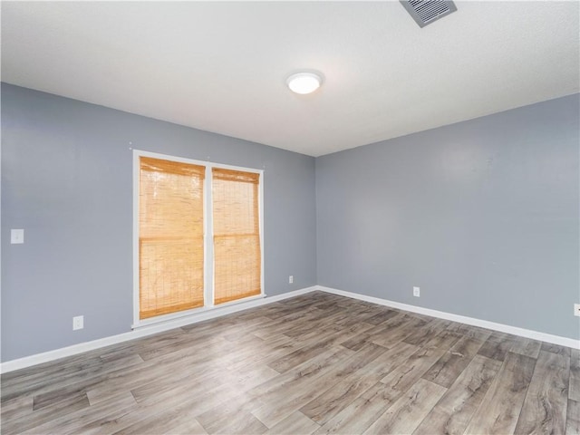 empty room with light hardwood / wood-style floors