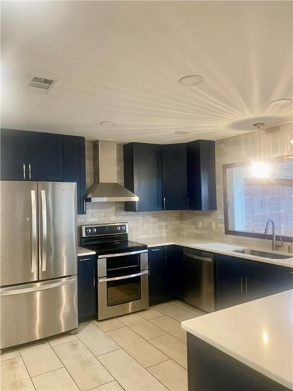 kitchen with sink, wall chimney exhaust hood, stainless steel appliances, tasteful backsplash, and light tile patterned floors