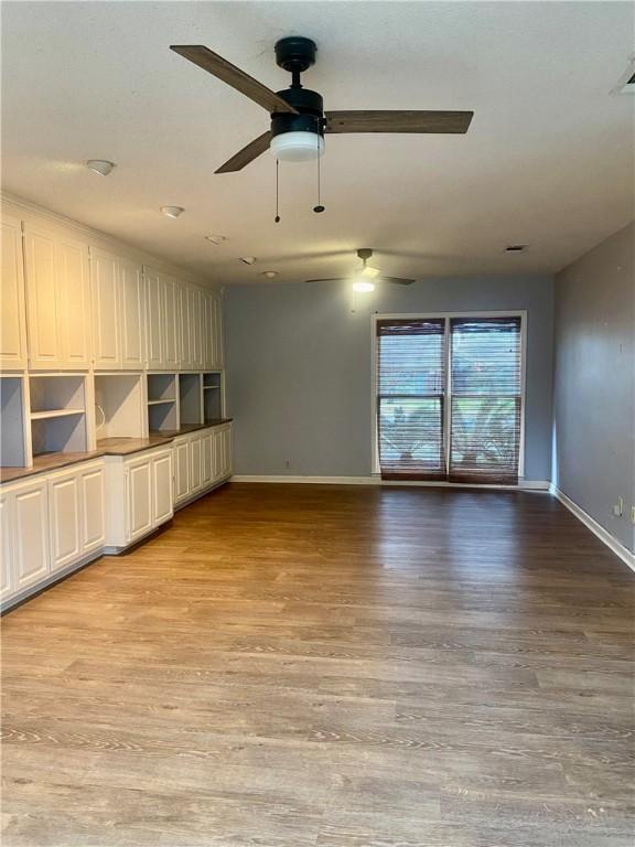 interior space with light hardwood / wood-style flooring and ceiling fan