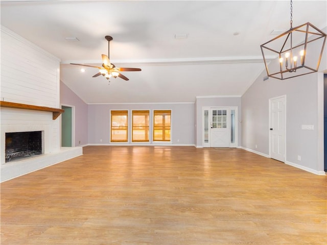 unfurnished living room featuring a fireplace, vaulted ceiling, and light hardwood / wood-style flooring