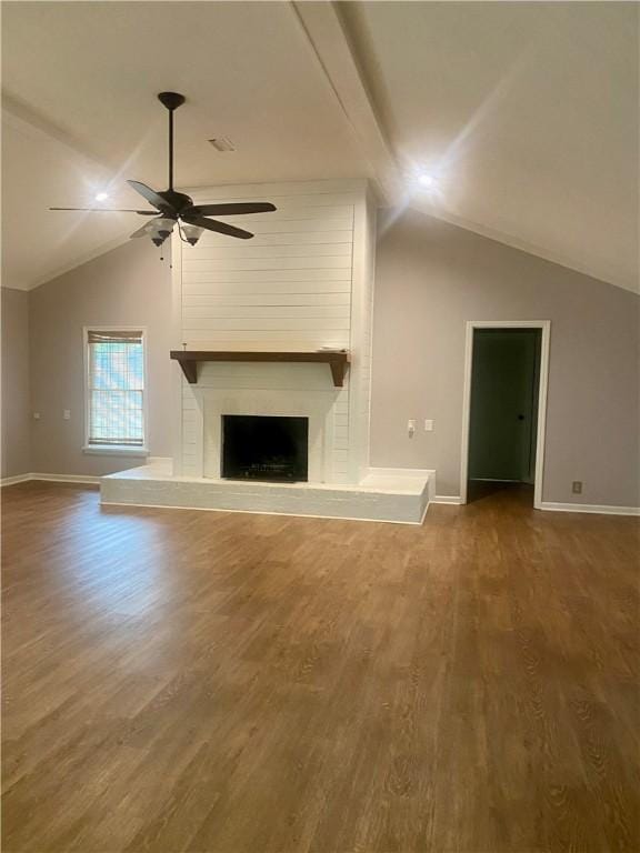 unfurnished living room with hardwood / wood-style flooring, ceiling fan, lofted ceiling, and a fireplace