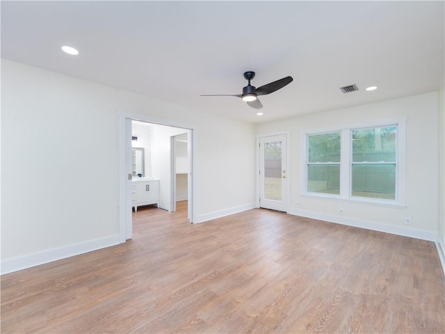 empty room featuring light wood-type flooring and ceiling fan