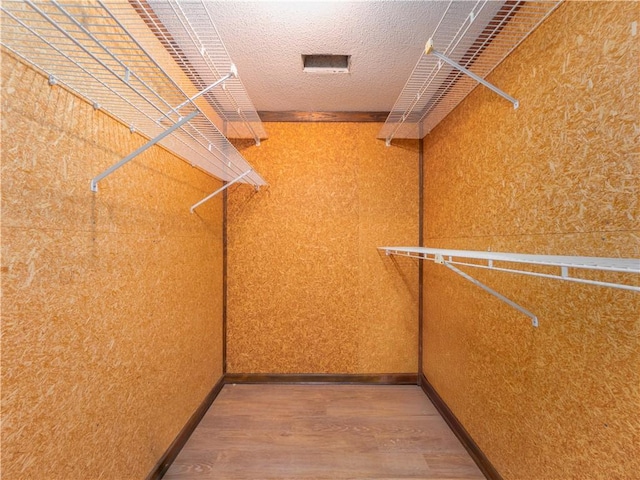 spacious closet featuring hardwood / wood-style flooring