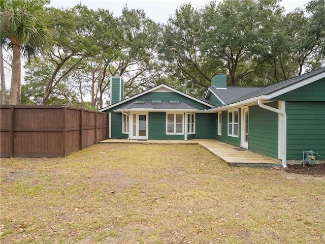 rear view of property with a lawn