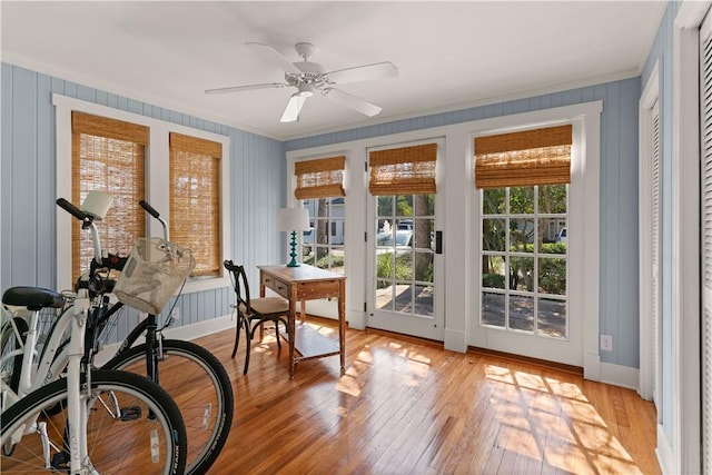 interior space featuring light wood-type flooring, ceiling fan, and a healthy amount of sunlight